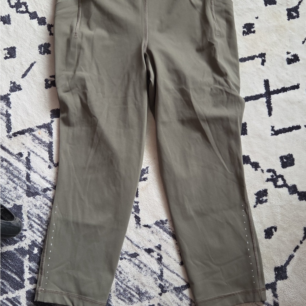Excellent condition size 10 Lululemon olive green leggings with reflector dots